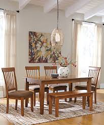 The coviar dining room table sets wonderfully clean lined profile is dramatically enriched with a complex burnished finish loaded with tonal variation and rustically refined character. Coviar Dining Table And Chairs With Bench Set Of 6 Ashley Furniture Homestore