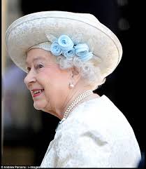 Queen steals the show in flower-trimmed hat as she dresses in stunning gold  and blue for 60th anniversary of Coronation