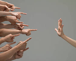 รูปภาพPerson pointing finger blaming others