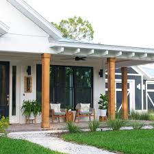 Black And White House Exterior One Story One Story White Modern Farmhouse Exterior Wraparound Porch Dark Blue Garage Metal Roof B Farmhouse Exterior Modern Farmhouse Exterior Farmhouse Style House