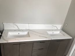 Calacatta Laza Quartz With Bookmatch Caped Backsplash Beach House Bathroom Calacatta Bathroom Bath Design