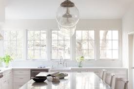 They're at opposite sides, but compliment each other in the room. Marble Top Kitchen Island With White Cane French Bar Stools Transitional Kitchen