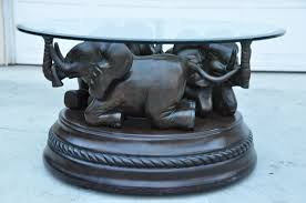 Iconic coffee table square 50''. Bombay Company Glass Top Coffee Table With 3 Elephant Sculpture Base