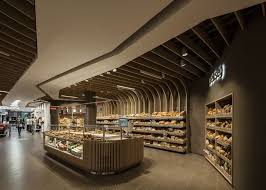 Spar Supermarket Displays Groceries Between Curved Wooden Ribs In 2020 Supermarket Design Supermarket Display Retail Design