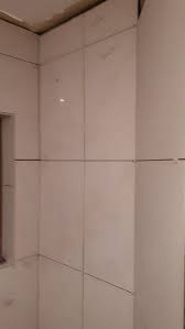 We are starting our farmhouse makeover with teaching the beginners guide to laying a tile floor. Tiling Uneven Walls Corners Looking Messy