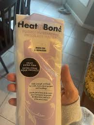 I want to take a design off of a T-shirt and put it onto a different shirt.  What light stabilizer would you use for cutting out the design? What heat  and bond