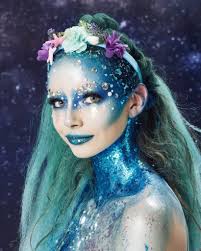 Halloween Hairstyles Woman Dressed As A Mermaid With Long Blue Hair And Unicorn Braid And Floral Headban Halloween Hair Mermaid Makeup Halloween Mermaid Hair