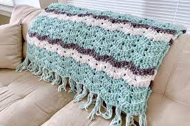 This easy weekend afghan is made with a giant crochet hook and three strands of yarn together, so it's soft, stretchy, and perfect year round. 20 Easy Crochet Afghans Perfect For Beginners Dabbles Babbles