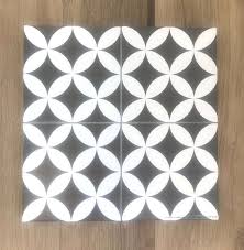 Choose an overall pattern, a centre pattern with plain border for a rug effect or simply a patterned border to frame a room. Picasso Petal Black Tiles