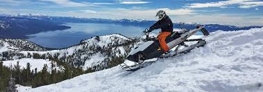 Snow blankets the mountains, capping its peaks. Tahoe Snowmobiling Snowmobile Tours Visit Reno Tahoe