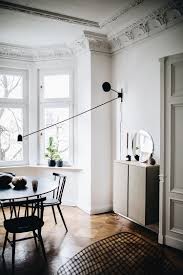 White walls and pale pink furniture allow dramatic pieces on the walls to pop in this dining room by nolen homes. A Cool Way To Light A Dining Room Without A Ceiling Light Dining Room Lighting Home Decor Interior Design
