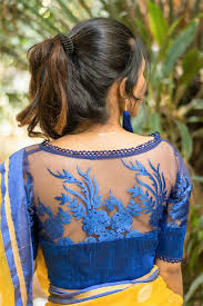 A plain boat neck blouse design with back keyhole looks phenomenal when combined with sleeves full of kutch and multicolored thread pattern work. Sizzling Boat Neck Blouse Designs With Net Can Amplify Your Outfit