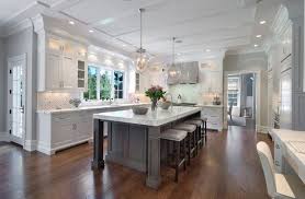 Dark floors, gray walls, white trim. White Kitchen Cabinets With Gray Kitchen Island Kitchen Home Decor Kitchen Design White Kitchen Design Kitchen Inspirations