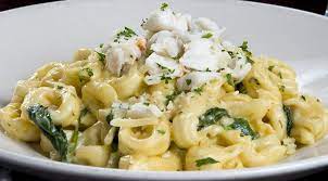 Three Cheese Tortellini With Jumbo Lump Crab Meat Tossed In A Spiced Parmesan Cream Sauce With Garlic Tortellini Recipes Seafood Entrees Crab Pasta Recipes