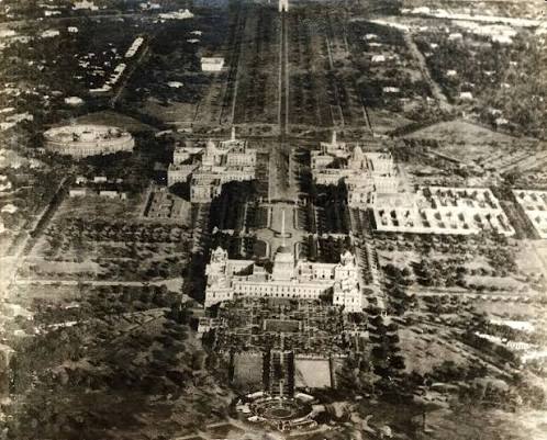 An aerial view of New Delhi, with the Viceroy's House (Rashtrapati Bhavan) and Mughal Garden. At the top left is the Council House (Parliament Of India) and at the end of the