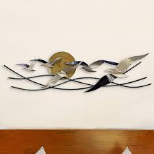 The wall decor features gold or silver metal with acrylic beads at the end. Winged Surfers 47 Wide Indoor Outdoor Metal Wall Art 96y77 Lamps Plus