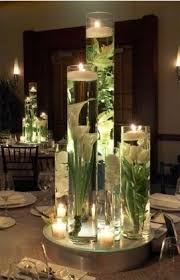 Using fake flowers for wedding centerpieces. Glue Fake Flowers To The Bottom Of A Tall Vas Popular Diy Crafts Pins On Pinterest Floating Candles Centerpieces Table Centerpieces