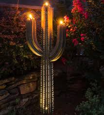 A decorative accessory with and without candles. Green Metal Saguaro Cactus Outdoor Torch Wind And Weather