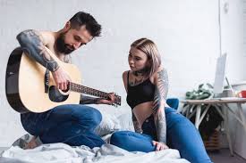 Maybe you would like to learn more about one of these? Tattooed Boyfriend Playing Guitar For Girlfriend In Bedroom Free Stock Photo And Image
