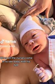 Woman shares photo of newborn son clutching her IUD