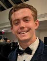 Patrick Kateregga, one of the most brilliant kids in the history of Aidan  College, receives a gift from the reverend around 2005.