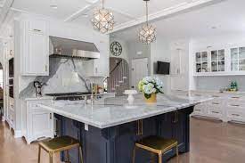 This kitchen also features wide plank hardwood flooring and the shiplap walls. Gorgeous Contemporary Kitchen With Gold Pendants Blue Island Erica Islas Hgtv
