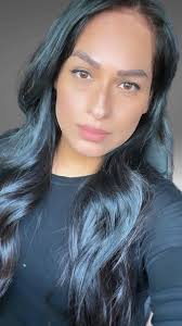 Hi! Could you please fix the background (remove cars and make it green) fix  my arms to look thinner, close my mouth a bit, and fix the hair giving me a  middle