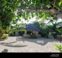 Thatch roof bungalows on the beach at Breakas Resort, Port ...