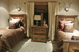 Bearskin rugs and game mounts, plaid blankets, and furniture hewn from logs. Luxe Hunting Lodge Rustic Bedroom Omaha By The Modern Hive Houzz