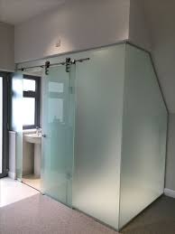 Showing off beautiful tile work with the right doors. A Bathroom Cubicle Clad With Frosted Glass And With A Main Sliding Door Is A Bold Idea For A Modern Space Glass Bathroom Shower Cubicles Glass Bathroom Door