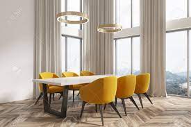 Yellows with a twinge of red typically read as a more muted alternative to pure yellow. Modern Dining Room Corner With White Walls A Wooden Floor And Stock Photo Picture And Royalty Free Image Image 93741557