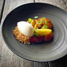 Chef in hotel or restaurant kitchen cooking, only hands. Poached Swedish Plum Flavored With Vanilla And Meadowsweet Served With Crumble And Vanilla Ice Cream Ceram Fine Dining Desserts Fine Dining Menu Food Plating