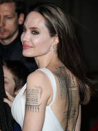 This tattoo at the base of her neck reads, 'know your rights' which is a title of a song made by her favorite band the clash. Angelina Jolie Reveals Her Huge Tattoo Collection As She Wears Backless Dress To Dumbo Premiere