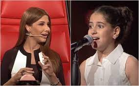 هل تذكرون جوان جبور نجمة ذا فويس كيدز شاهدوا كيف فاجأت الجميع بشكلها وصوتها بعد أن كبرت lab coat fashion coat