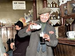 15 January 1940 Man pours ground ginger in his pint of beer. As practised  by stevedores and dockers during cold weather, ground ginger is found in  many riverside inns near wharves, though