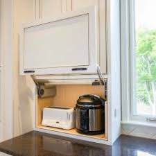 We had a custom made kitchen storage lift made to hide our coffee maker. Smart Design Hidden Kitchen Storage Florida Design Works