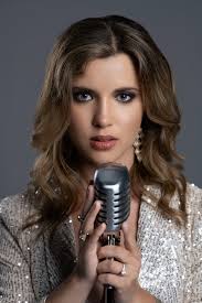 Bit of a belated happy new year everyone! As you can see, I've been a bit  preoccupied… Photo description: Rachael sitting reclined in a rocking chair  cuddling a small baby. They look