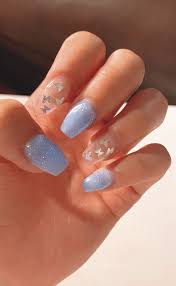 These coffin nails have a light ombre design with lots of rhinestones. Light Blue Nails With Stars Short Acrylic Nails Designs Square Acrylic Nails Acrylic Nails Coffin Short