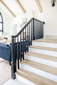 Stair spindles are the vertical supports that attach to the stair railing and the bottom railing or surface running along the stairs. How We Completely Updated Our Stair Railings By Only Swapping Out The Balusters Chris Loves Julia