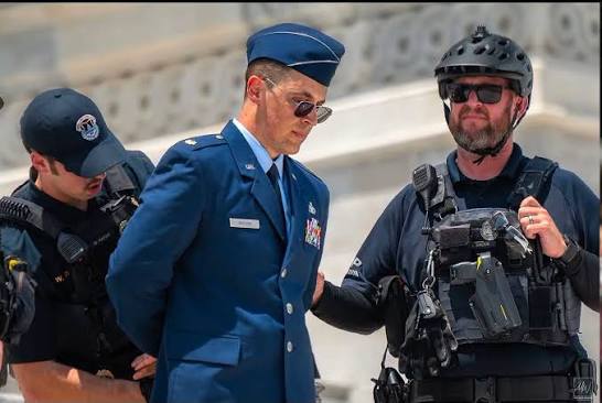 This is a significant moment. Active-duty Air Force Major Jason Watson  stood on the steps of the U.S. Capitol in uniform, publicly criticized the  Commander in Chief, and was arrested during what