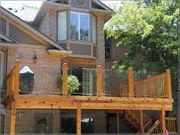 Looking to replace wooden railings to maximize views on our decks but not sure which material is the best in terms of glass railing is much better than plexiglass for outdoor deck railings. I Like How They Used Spindles On The Sides And Glass In The Back So You Still Patio Railing Glass Railing Deck Wooden Deck Designs