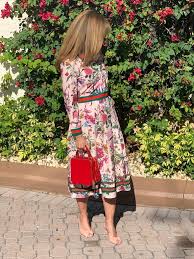 A casual summer bridal shower look with a white top and shorts, white heels with straps and sunglasses. What To Wear To A Bridal Or Baby Shower As Guest A Two Drink Minimum