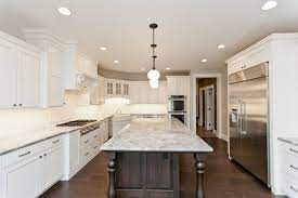 Stunning White Kitchen Cabinets With Large Island In Wood Tone Skogman Homes Cedar Rapids Iowa Whitekitchen Newconstructio Kitchen Inspirations Kitchen Home