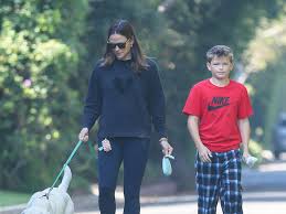 Jennifer Garner kisses Samuel Affleck while enjoying a relaxing walk with  the family dog