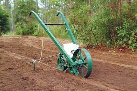 Choose The Right Garden Seed Planter Sustainable Farming Mother Earth News Seed Planter Garden Tools Garden Seeds