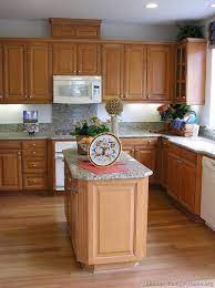The pastel paint color brightens the space and reflects its shiny white subway tile backsplash. Pin By Deana Perrotte On For The Home Light Wood Kitchens Wood Kitchen Cabinets Light Wood Cabinets