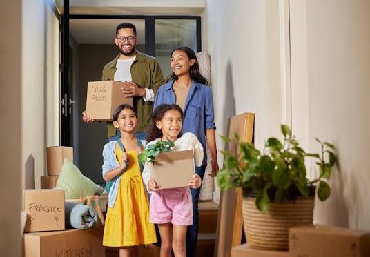 Family preparing for a house move in Mauritius with boxes and furniture