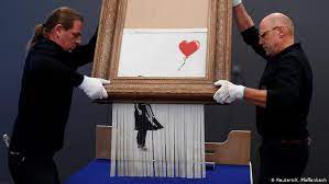 For banksy put his artwork through the shredder at the climax of the busiest week in the london art this is now part of art history in its shredded state and we'd estimate banksy has added, at a. Banksy S Shredded Girl With Balloon Now On Display In Germany Arts Dw 05 02 2019