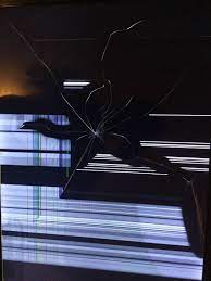 Selective focus of cheerful man with broken leg watching tv near popcorn on table in living room. Solved Broken Tv Screen Displays Linus Tech Tips