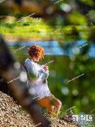 Attractive 40s woman in nature stalked by voyeur through vegetation, Stock  Photo, Picture And Rights Managed Image. Pic. Y1C-3822904 | agefotostock